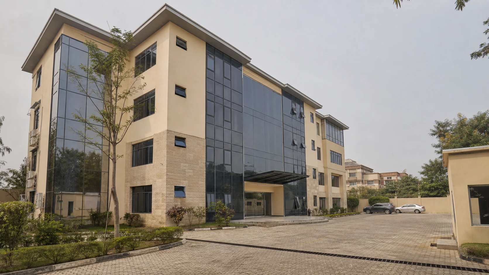 Occupied Abuja commercial building with aluminium windows and curtain-wall glazing.