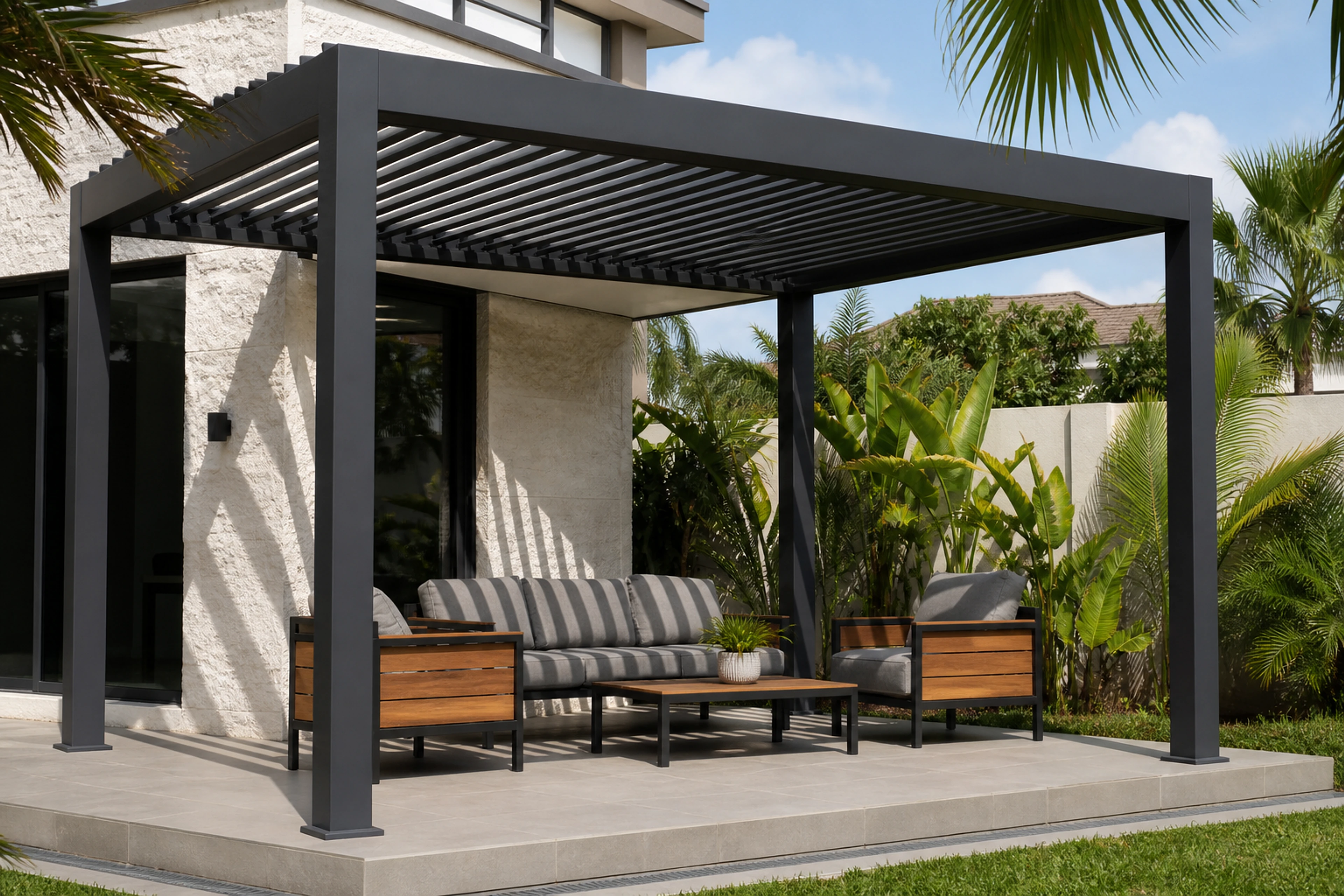 Dark aluminium pergola with a slatted roof above outdoor seating and a coffee table.